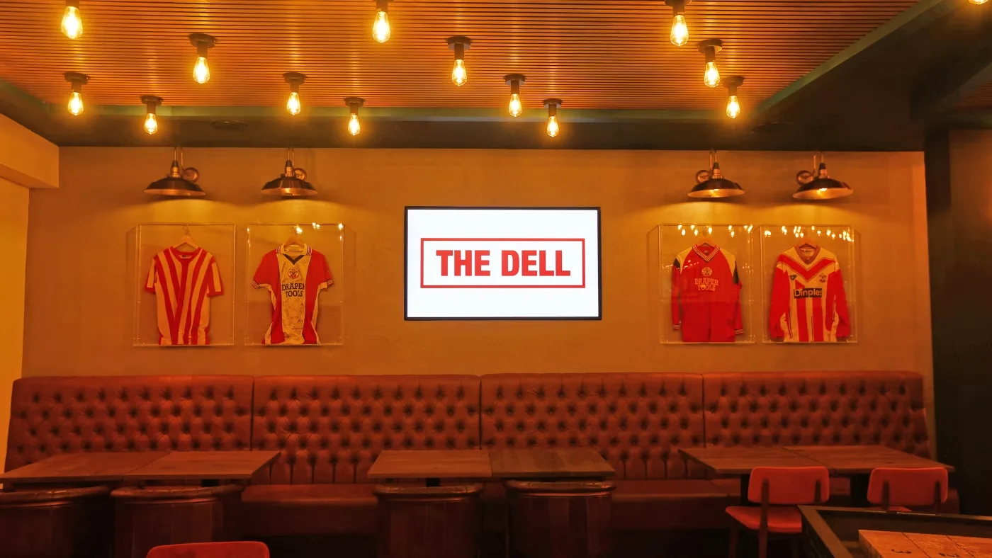 Southampton shirts and The Dell name on the wall