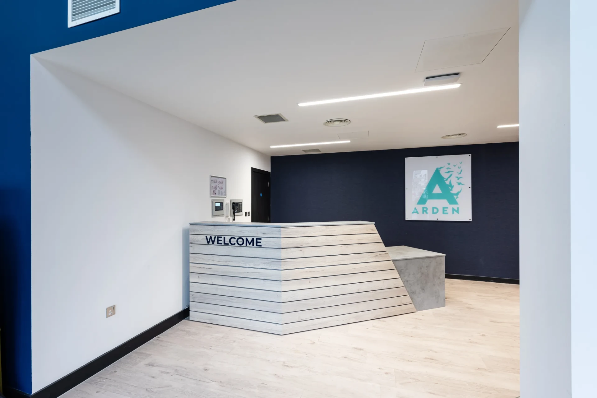 Arden University branded reception with welcome desk