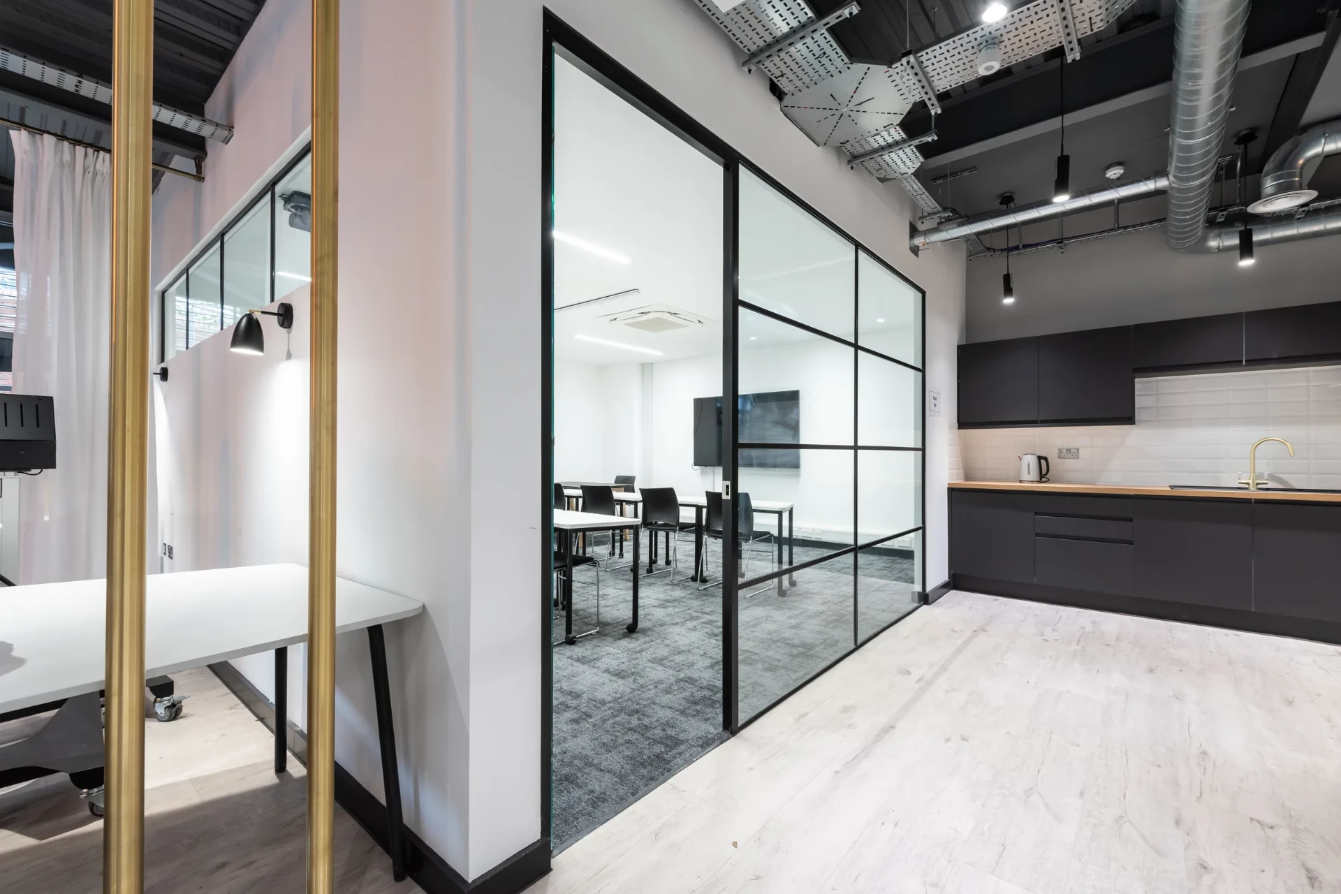 Black-framed glazing and kitchen at Arden University