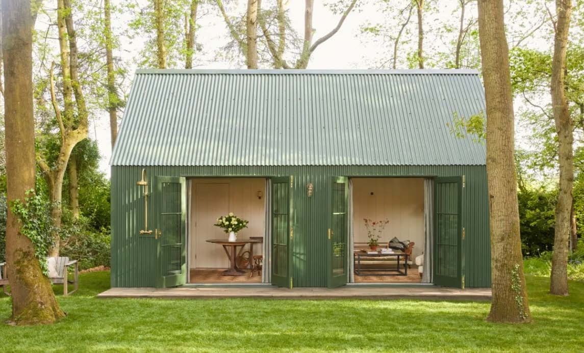 Pitched-roof garden room in a woodland garden
