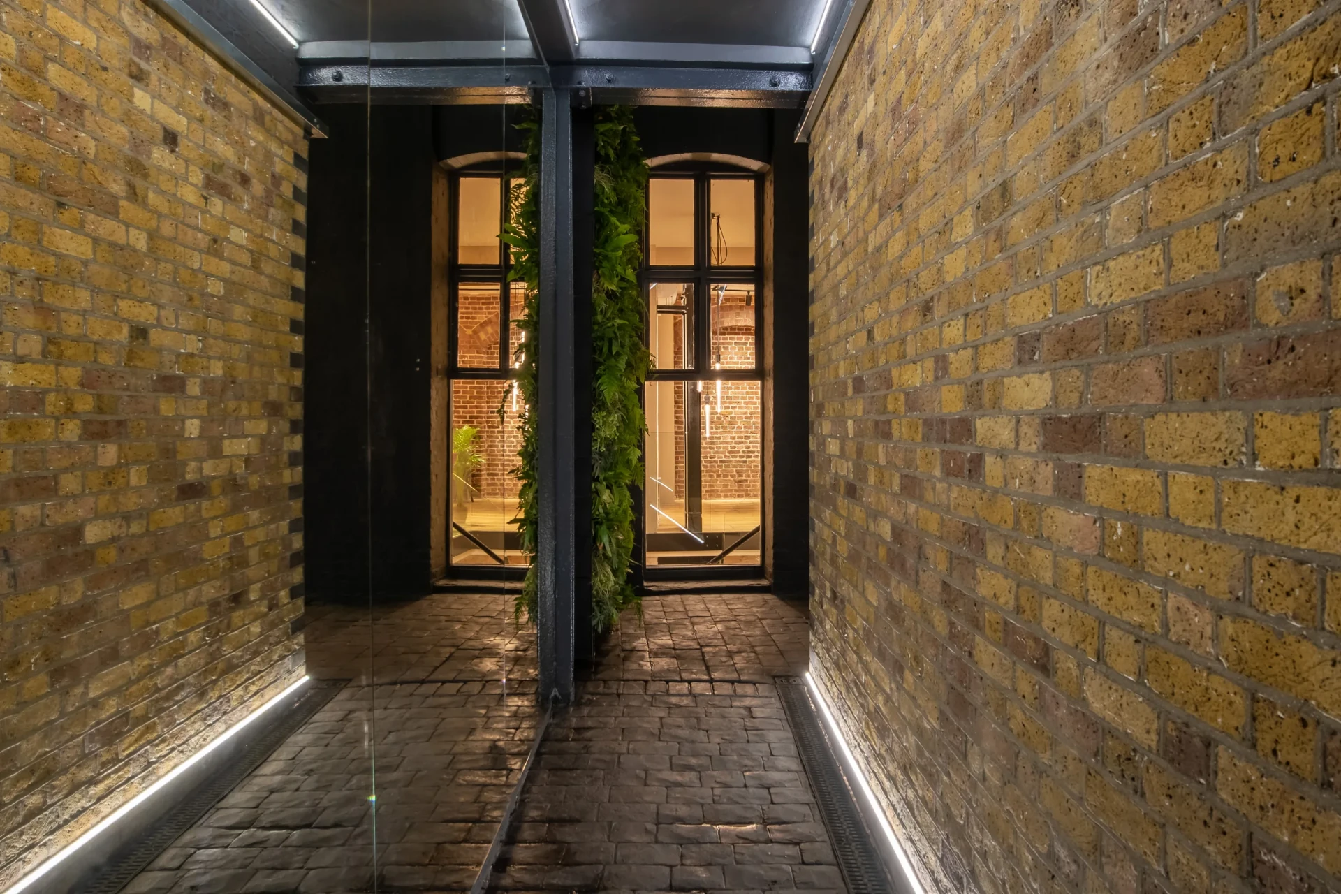Original brickwork and planting in the Endell Street passage