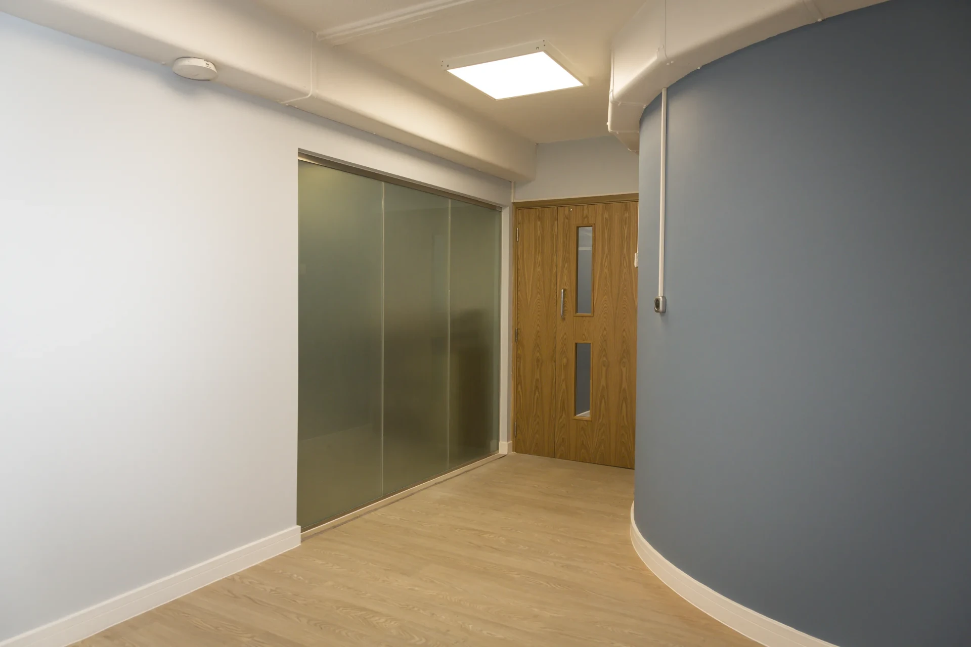Curved blue corridor at Camberley Health Centre