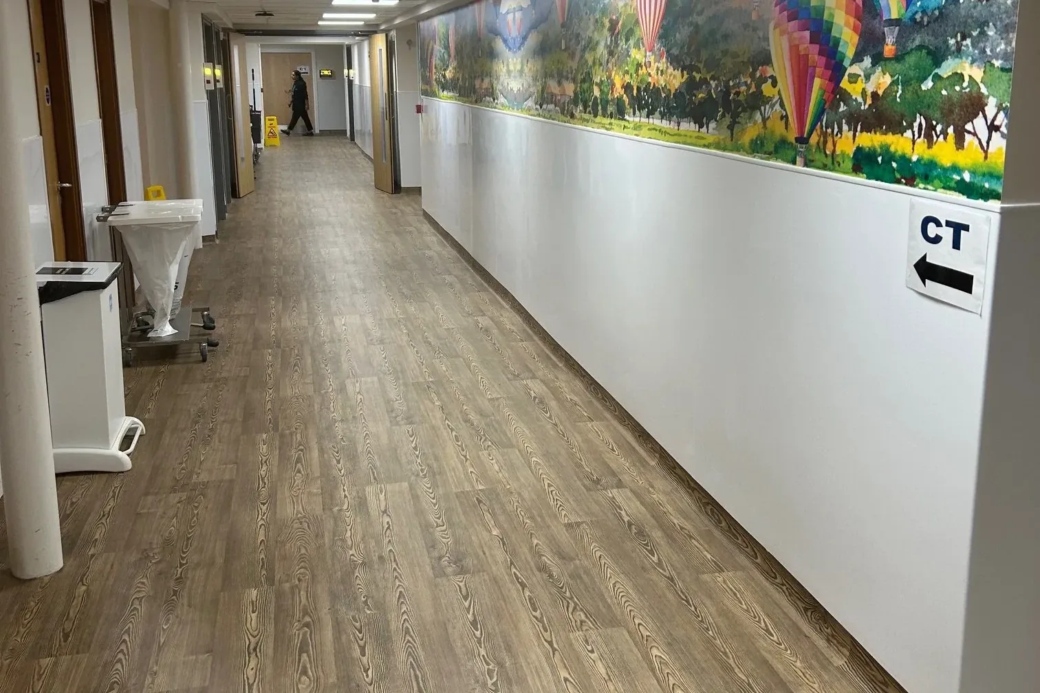 A Wexham Park Hospital corridor with a colourful balloon mural above new panelling
